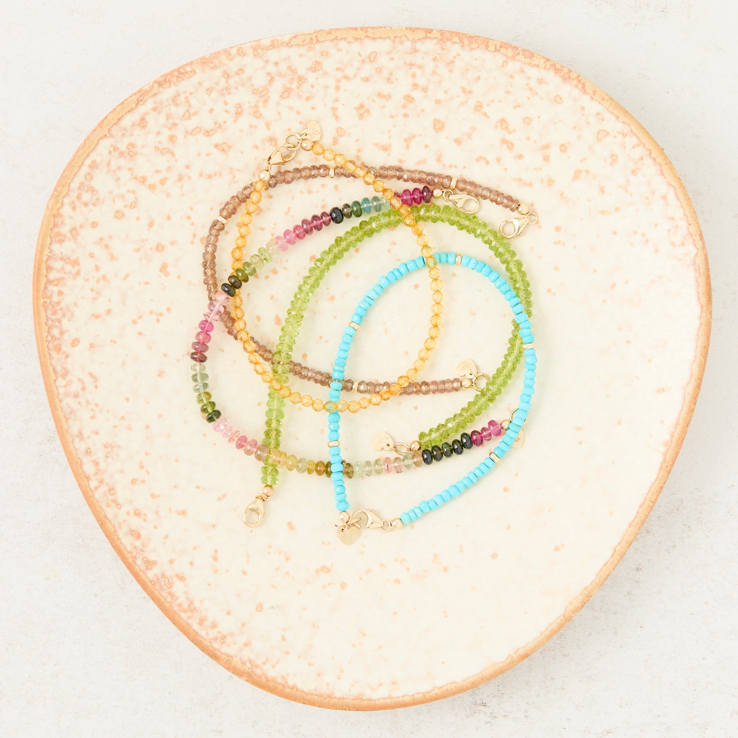 Colorful gemstone bracelets with solid gold clasp styled in Nashville, Tennessee