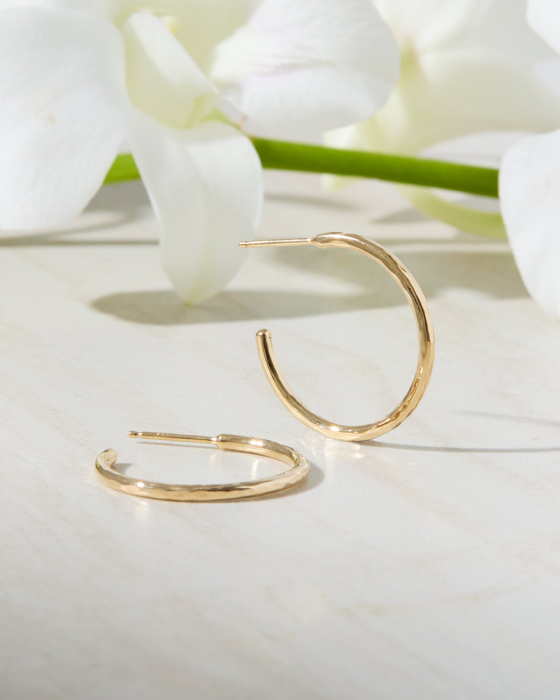 Gold hoop earrings with a hammered texture, handmade in Nashville, TN